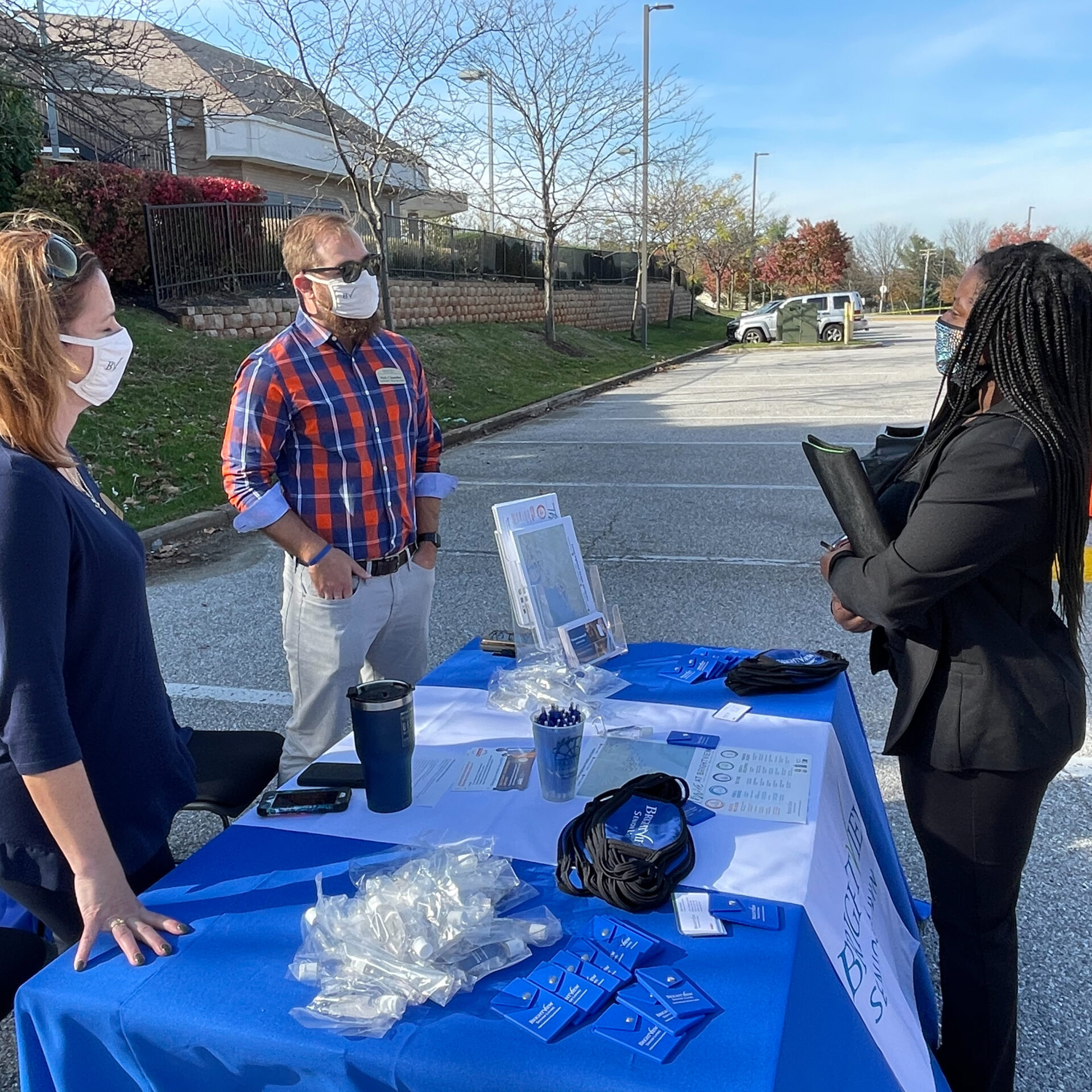 Job Seeker Talking with Business Representatives at Event